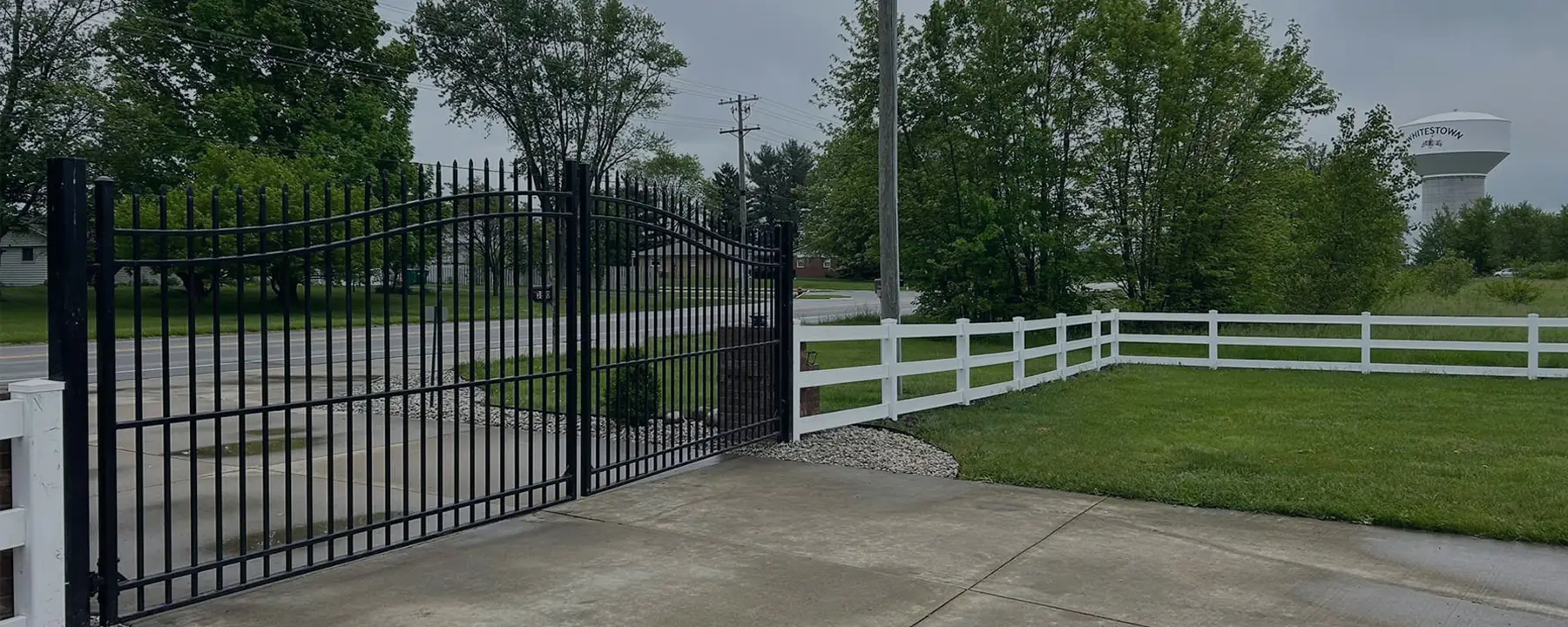 vinyl rail fence with automated steel gate installed by Indy's Finest Fence in Indianapolis Indiana